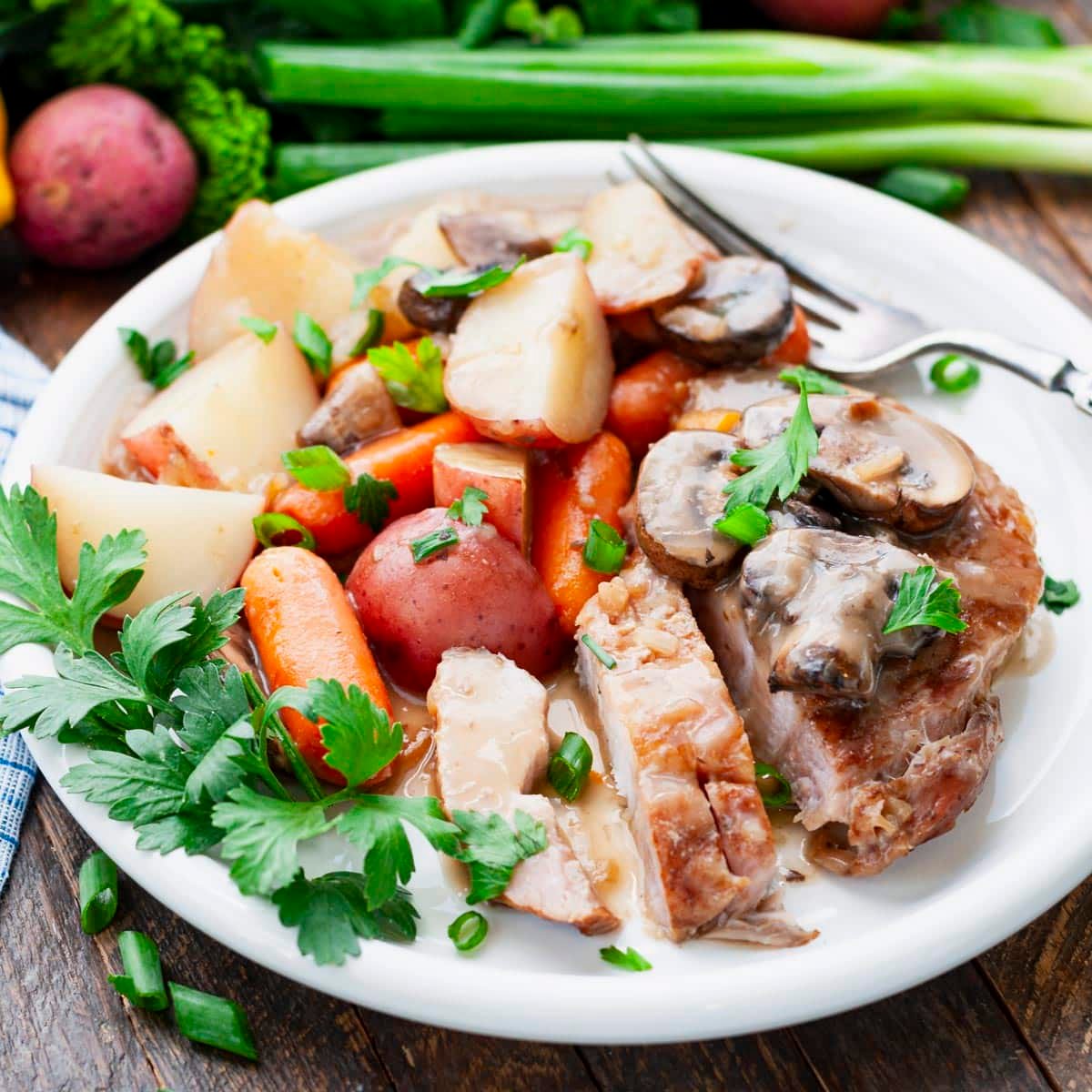 Square side shot of a plate of easy slow cooker pork chops.