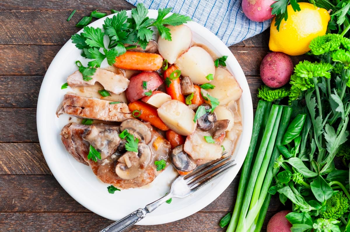 Horizontal overhead shot of easy Crock Pot pork chops with vegetables.