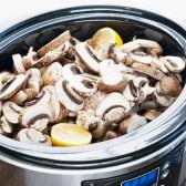 Sliced mushrooms in a slow cooker.