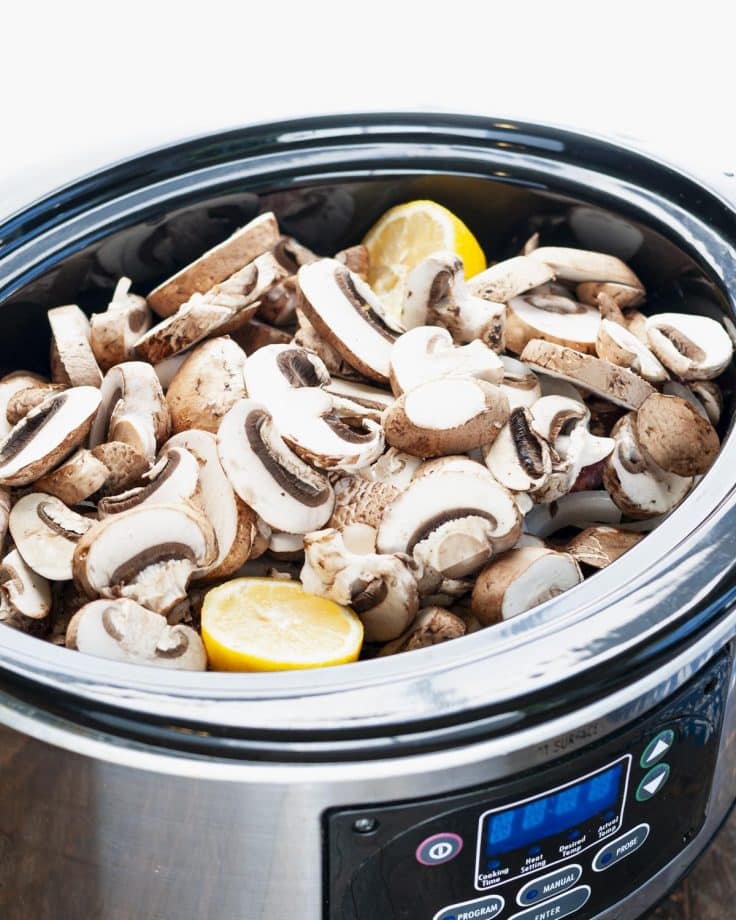 Sliced mushrooms in a slow cooker.