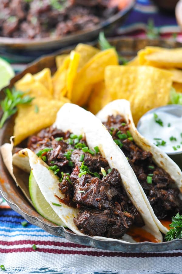 Close up front shot of crock pot beef barbacoa tacos on a plate