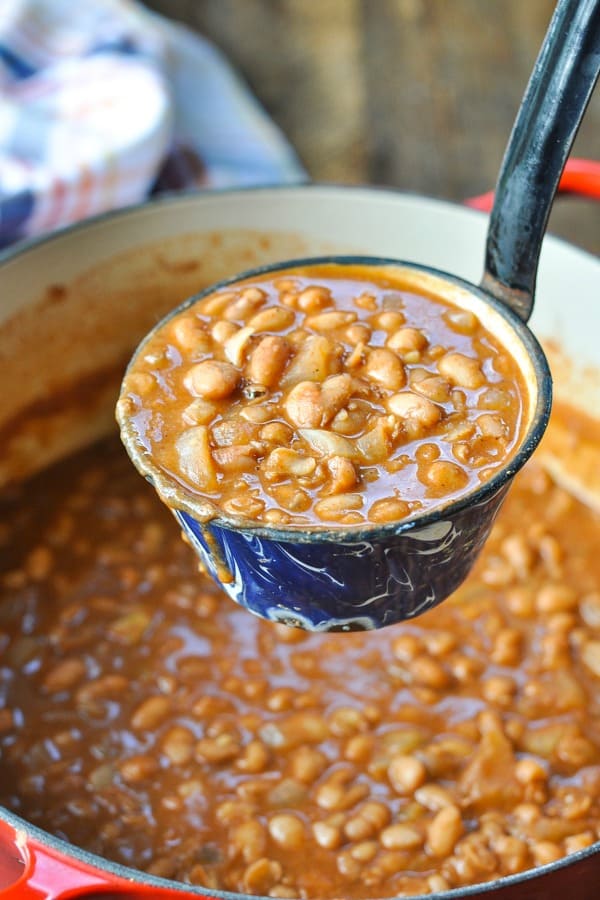 Ladle full of ranch style beans from a dutch oven