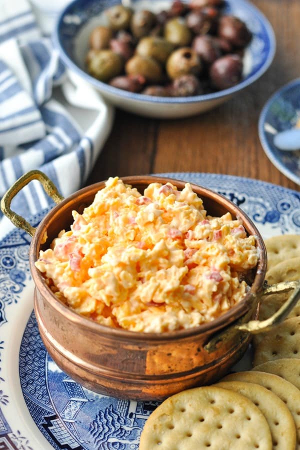Front shot of a bowl of pimento cheese on a blue and white plate