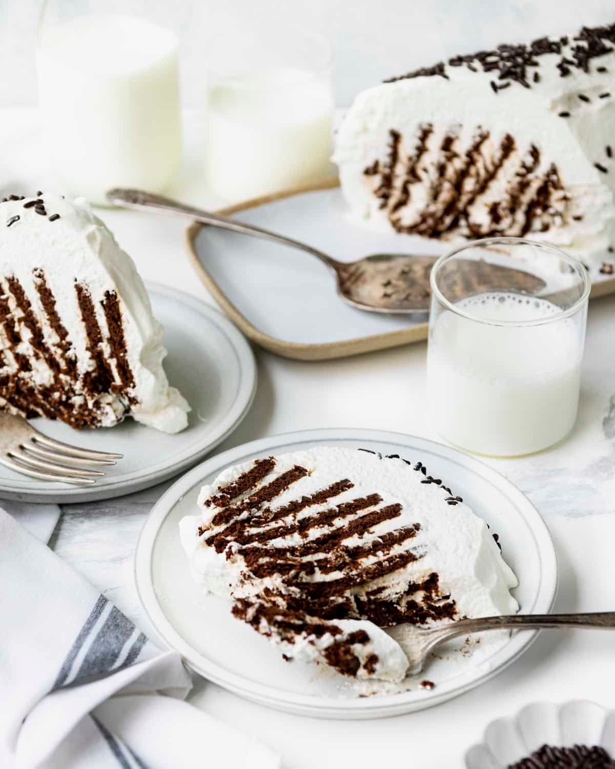 Slices of old fashioned icebox cake on a white table.