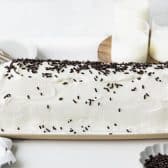 Finished shot of an original icebox cake recipe on a long platter with chocolate sprinkles on top.