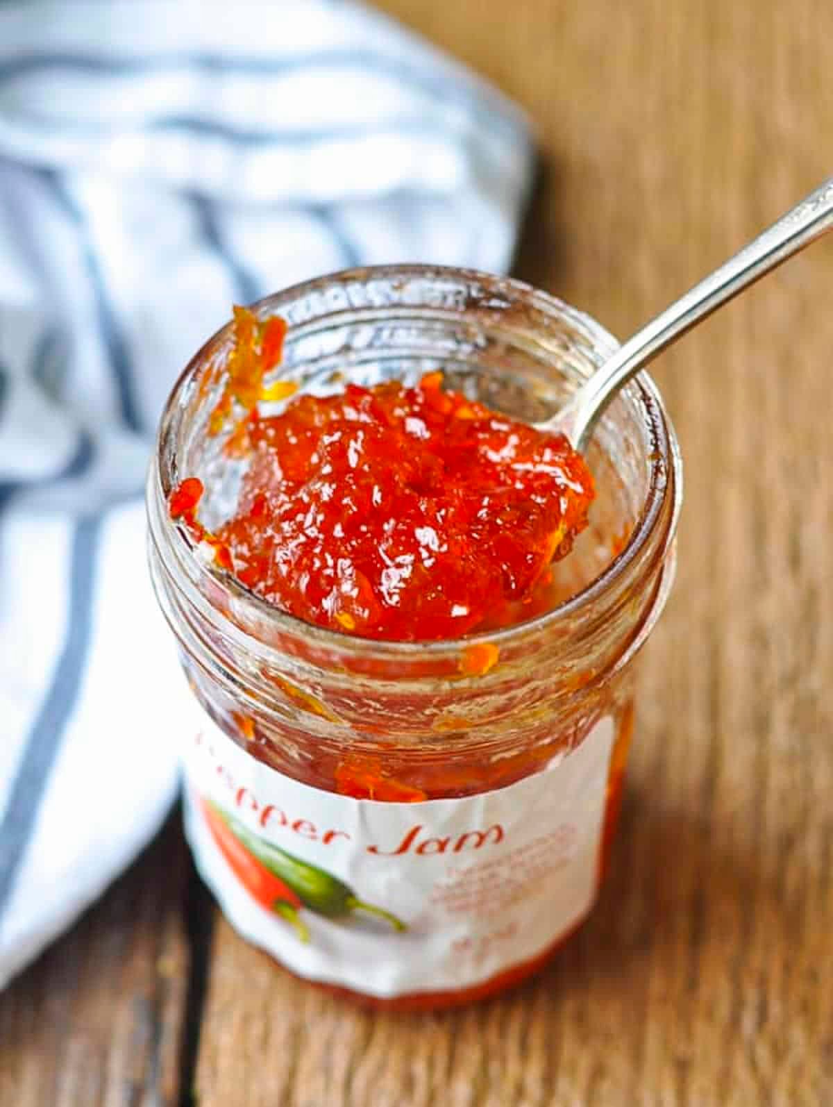 Spoon in a jar of hot pepper jam.