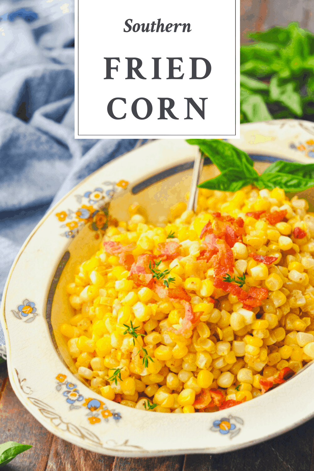 Close up side shot of skillet fried corn in a serving bowl with text title box at the top