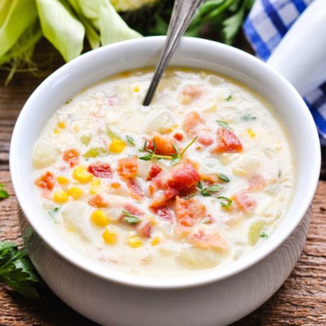 Square close up shot of a white bowl full of the best corn chowder recipe.