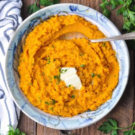 Square overhead shot of a bowl of mashed sweet potatoes.