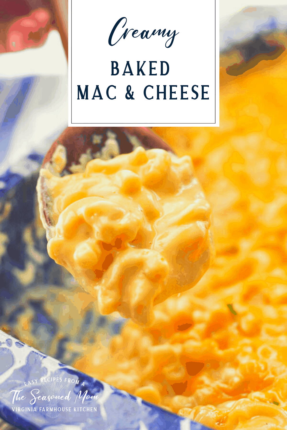 Close up shot of a spoonful of creamy baked macaroni and cheese with text title box over top