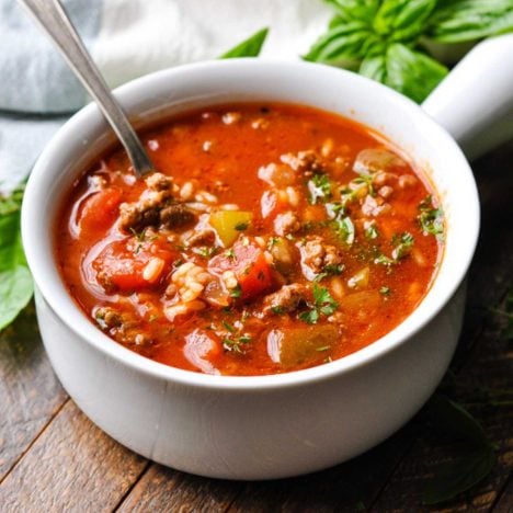 Square side shot of a white bowl full of stuffed pepper soup.