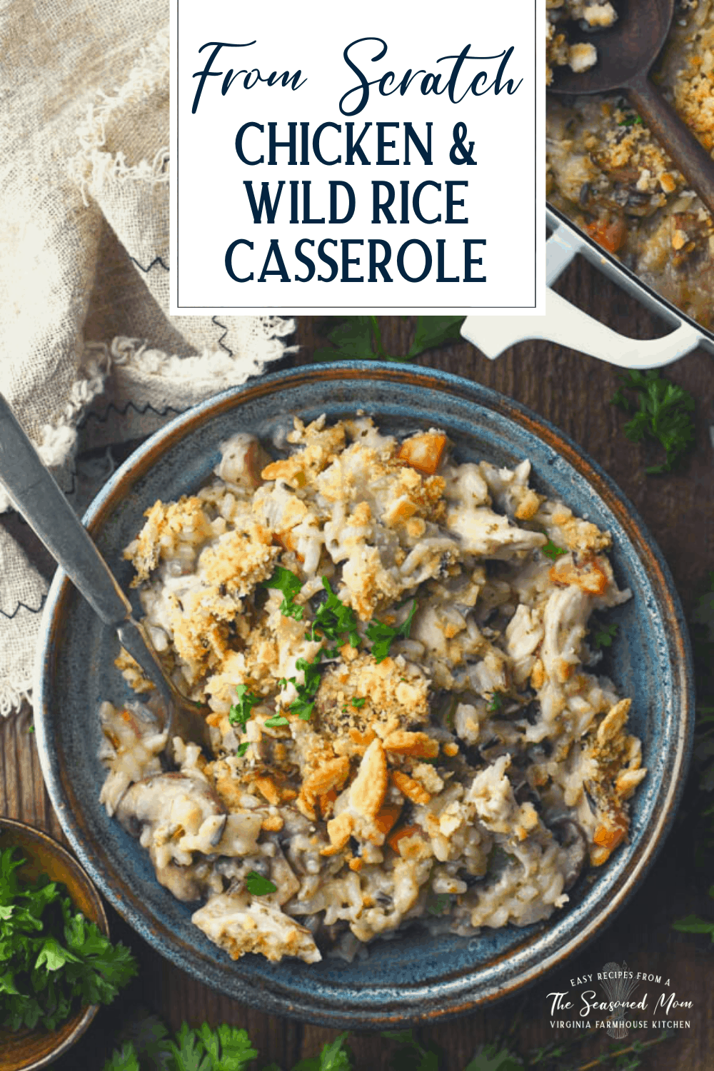 Overhead shot of a bowl of baked chicken and wild rice casserole with text title overlay