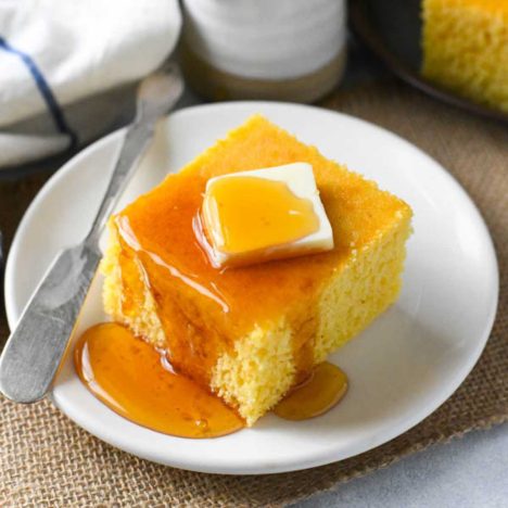 Square side shot of a slice of honey cornbread.