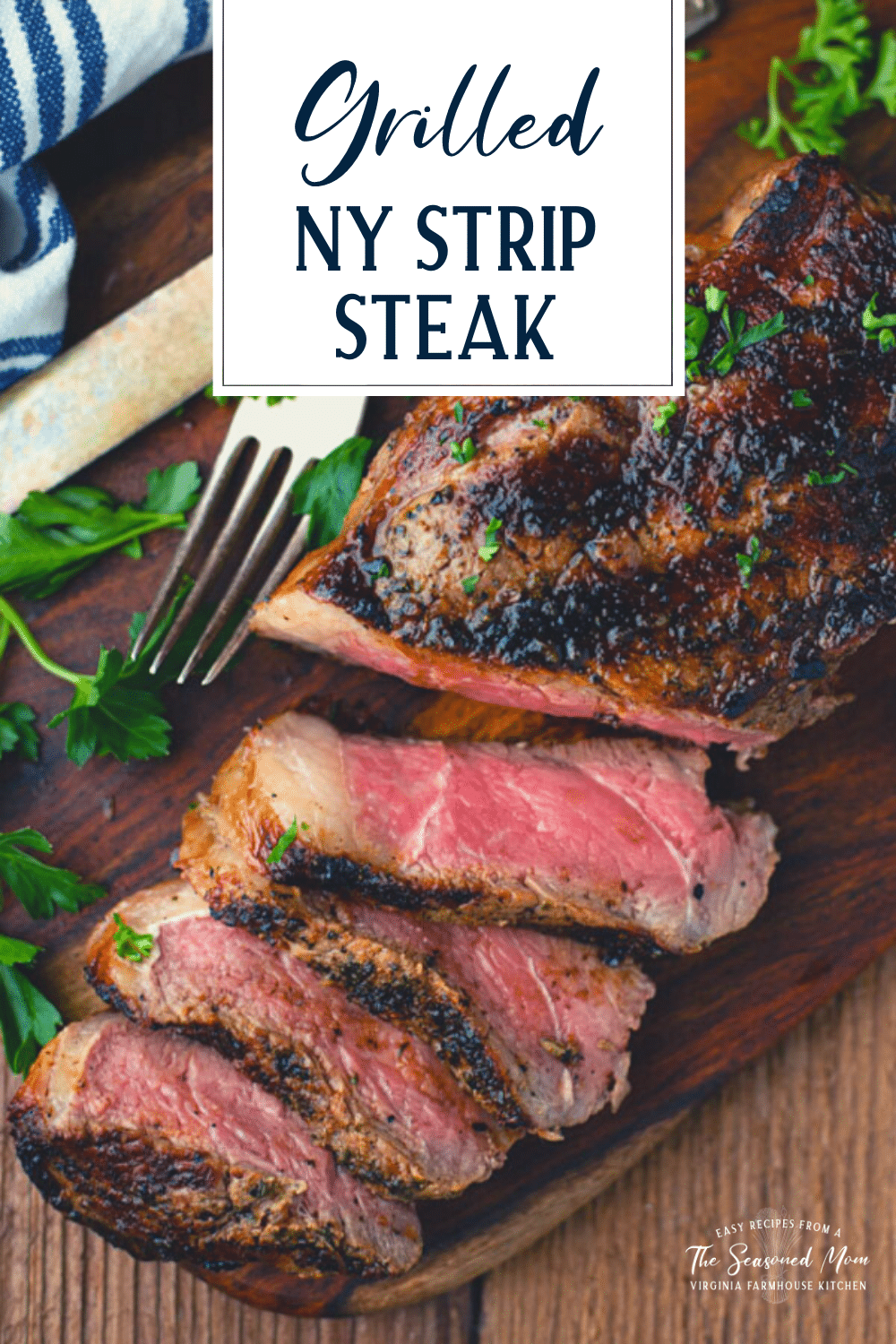 Overhead shot of grilled New York Strip on a cutting board with text title overlay at top