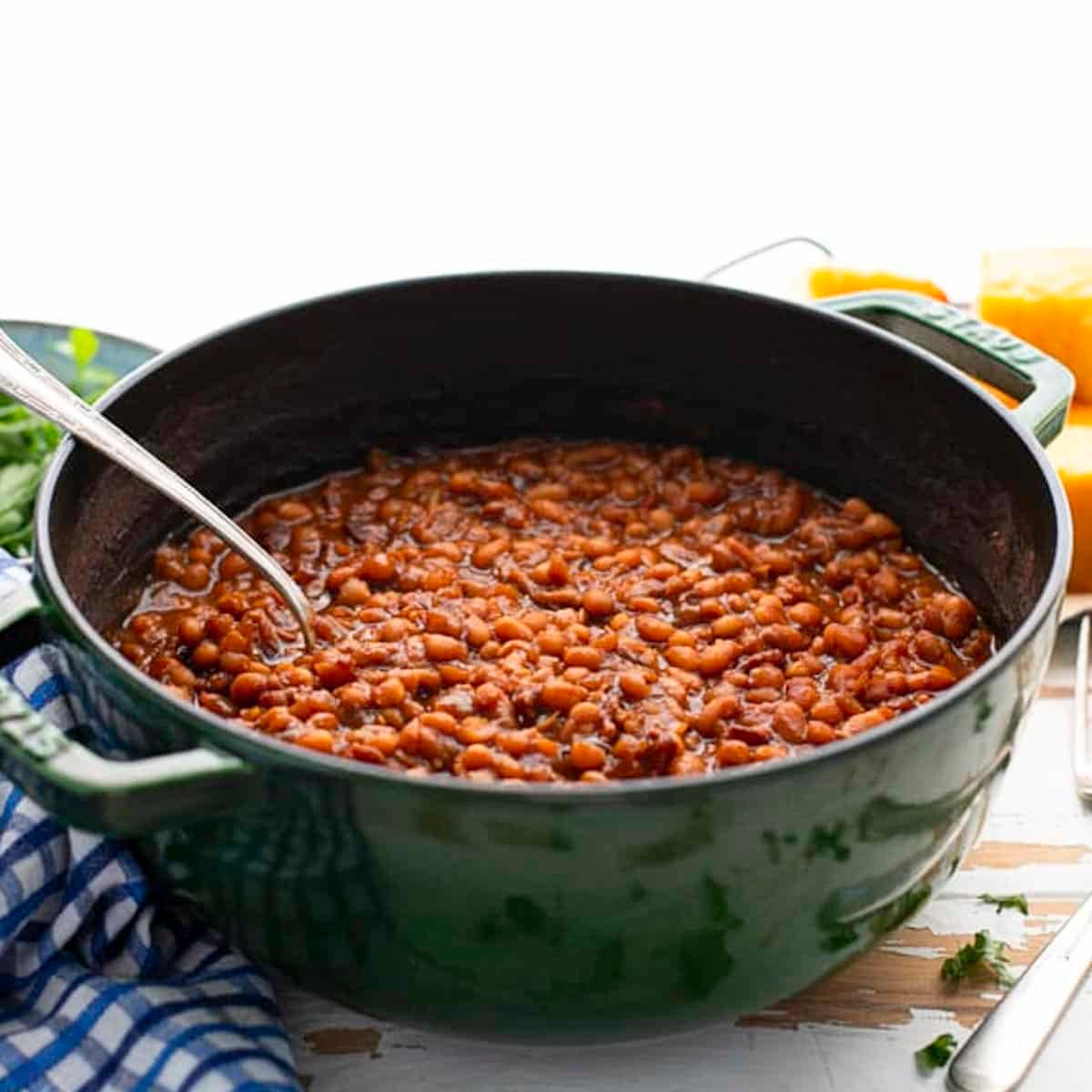 Square side shot of a pot of baked beans with bacon.