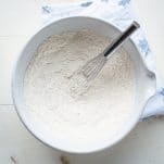 Flour and other dry ingredients in a white mixing bowl