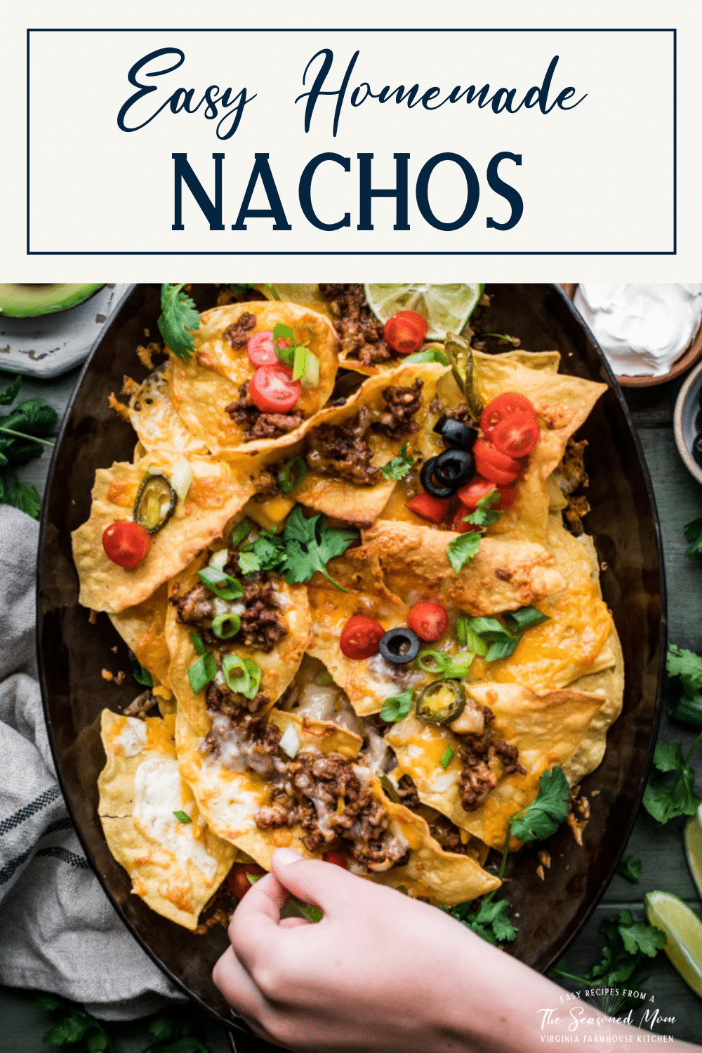 Pan of loaded homemade nachos with text title box at top
