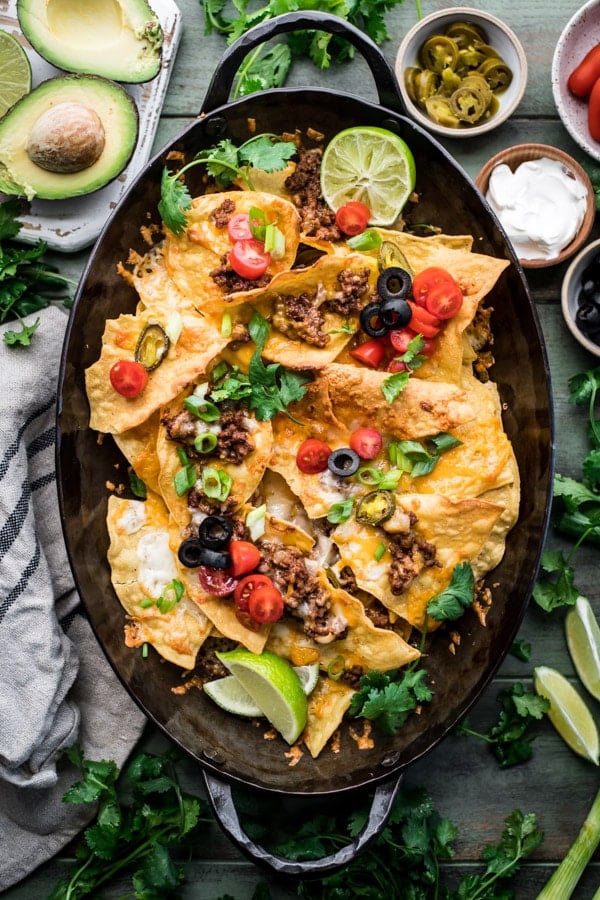 Overhead shot of the best homemade nachos recipe with toppings