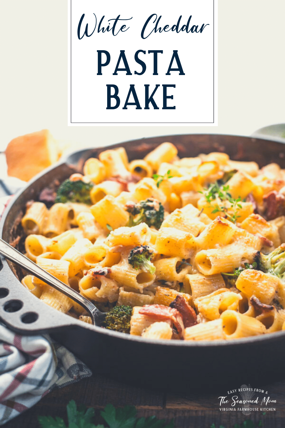 Close up side shot of cheesy rigatoni pasta bake with text title overlay