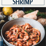Side shot of a bowl of garlic butter shrimp with text title box at top.
