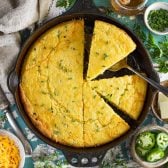 Square overhead image of jalapeno cheddar cornbread in a cast iron skillet.