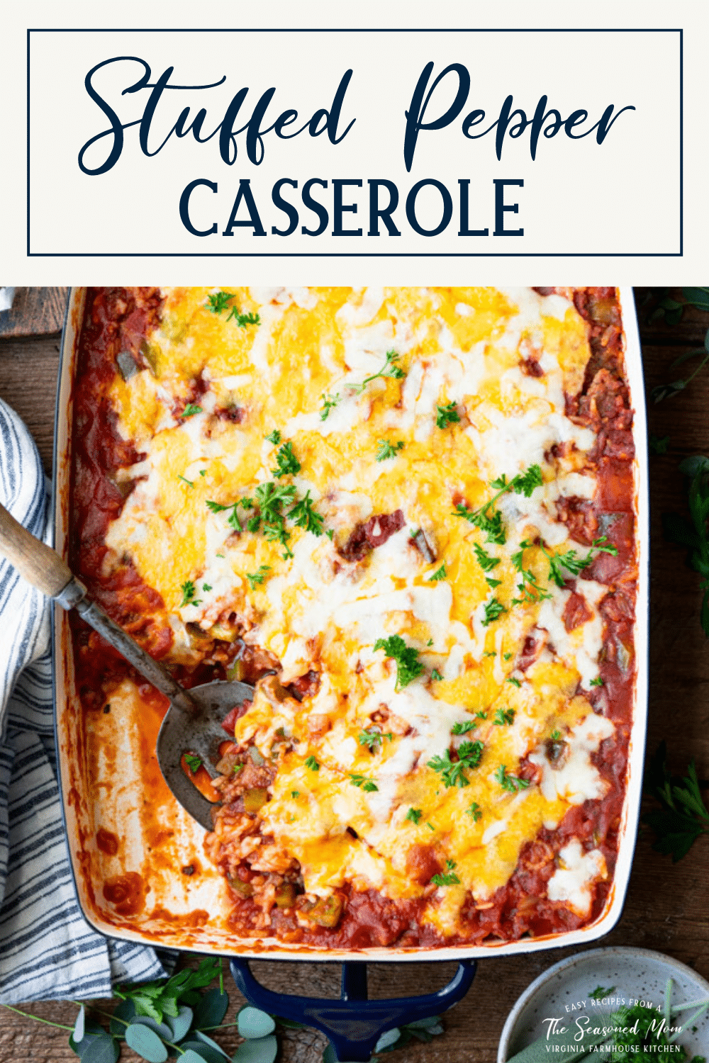 Overhead shot of stuffed pepper casserole on a table with text title box at top