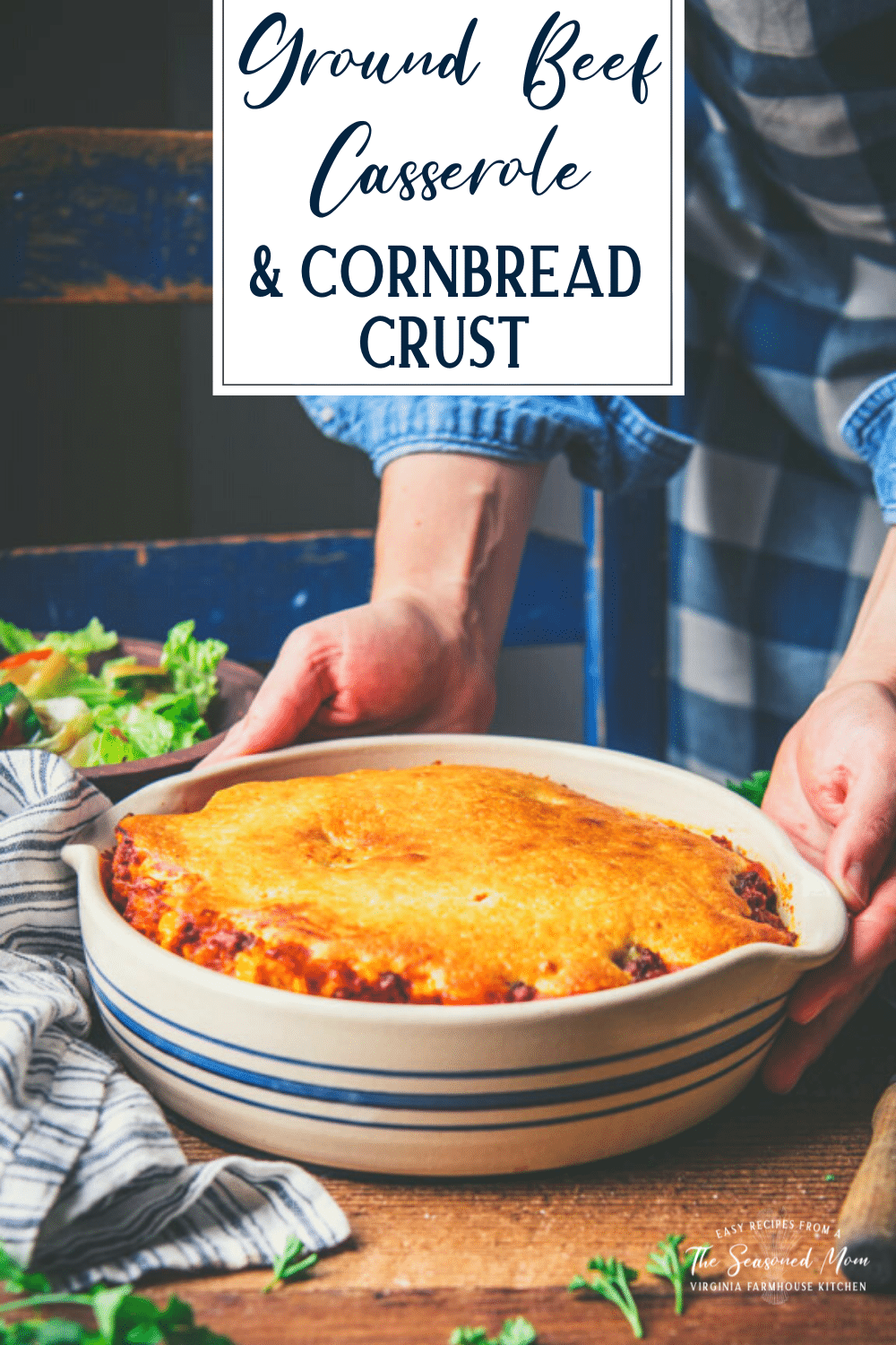 Hands holding a ground beef casserole with text title overlay