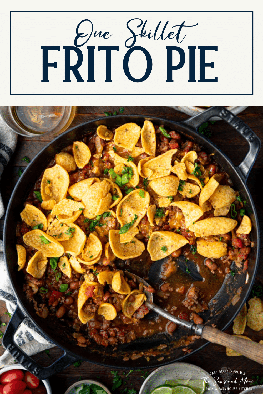 Serving spoon in a dish of frito pie with text title box at top.