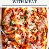 Stuffed shells with meat and text title box at top.