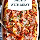 Stuffed shells with meat and text title overlay.