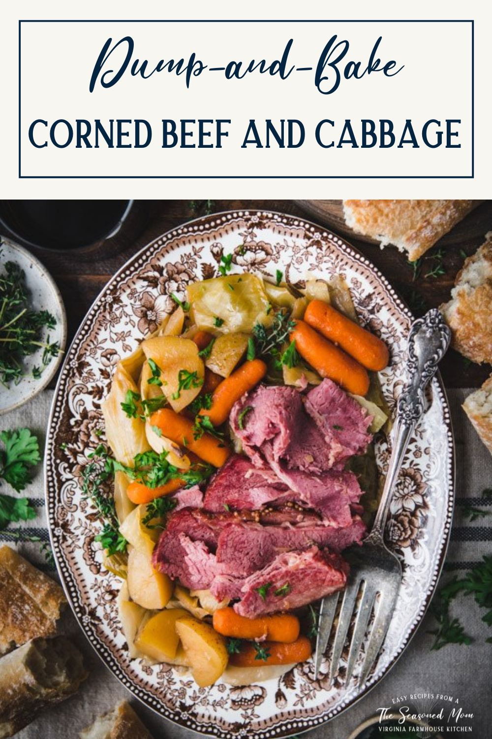 Overhead image of a platter of corned beef and cabbage on a dinner table with a side of bread and text title box at top.