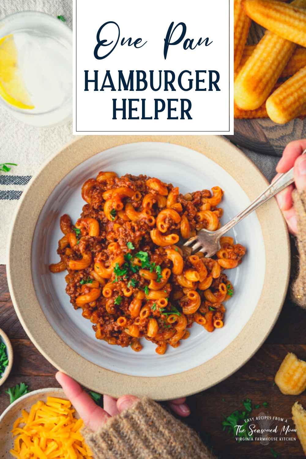 Hands eating a bowl of hamburger helper with text title overlay.