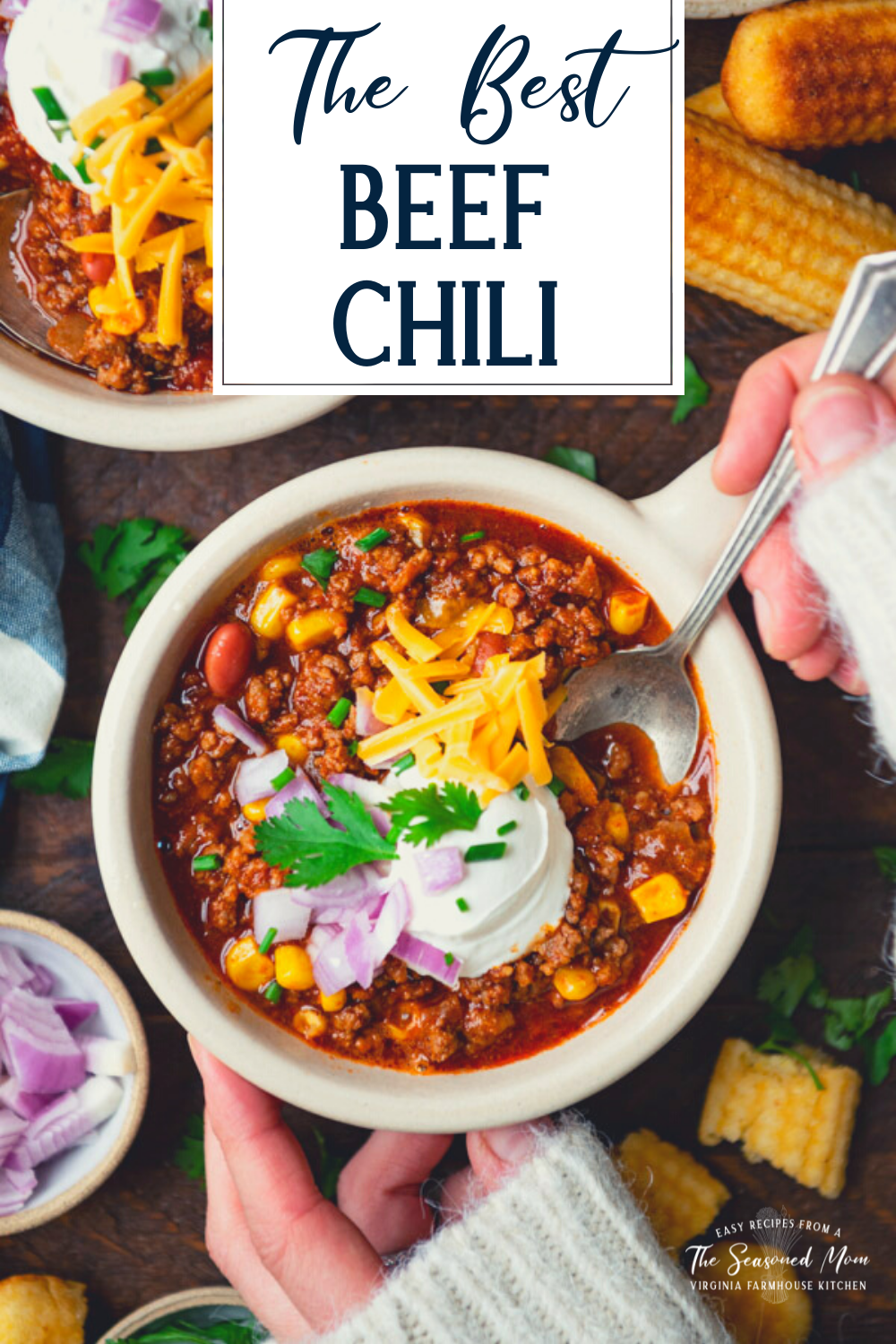 Overhead shot of hands eating a bowl of beef chili with a spoon and text title overlay.