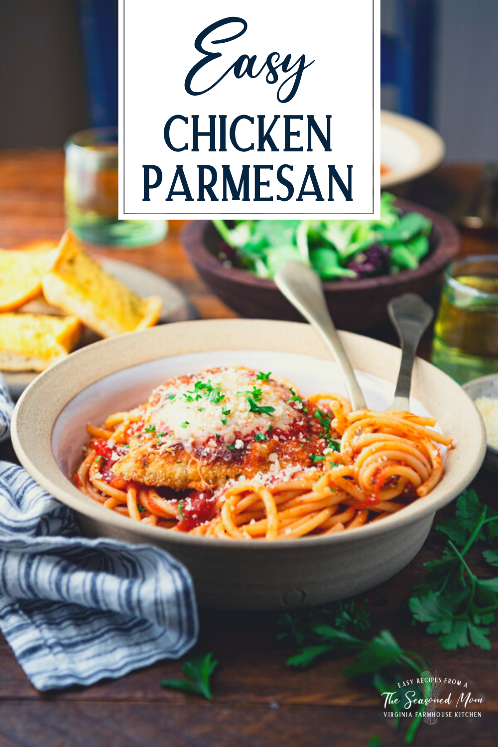 Side shot of easy chicken parmesan recipe on a dinner table with text title overlay