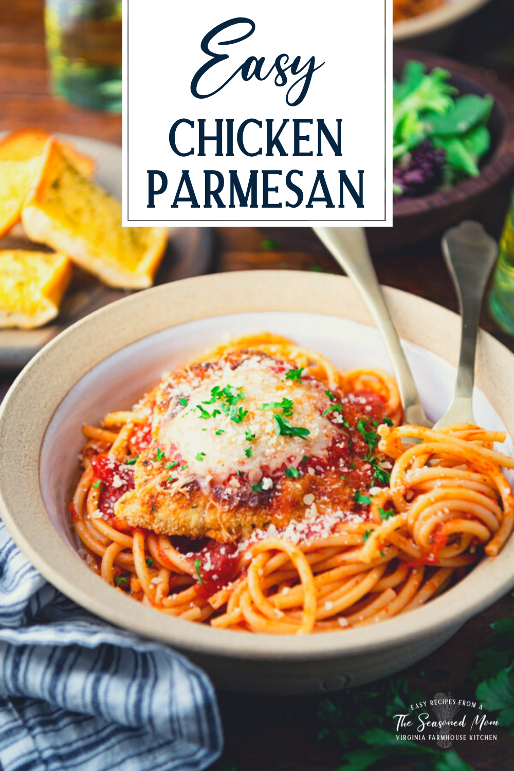 Close up side shot of a bowl of the best chicken parmesan served with spaghetti and text title overlay