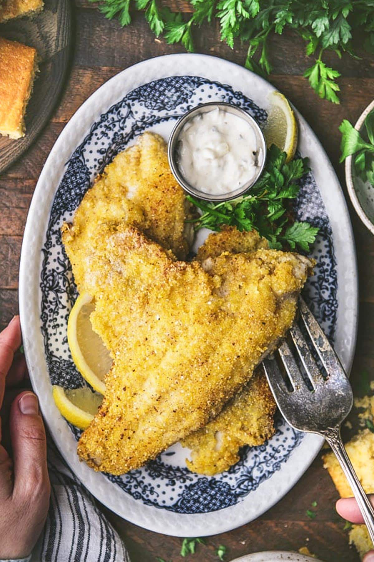 Overhead shot of a blue and white plate with southern fried catfish.