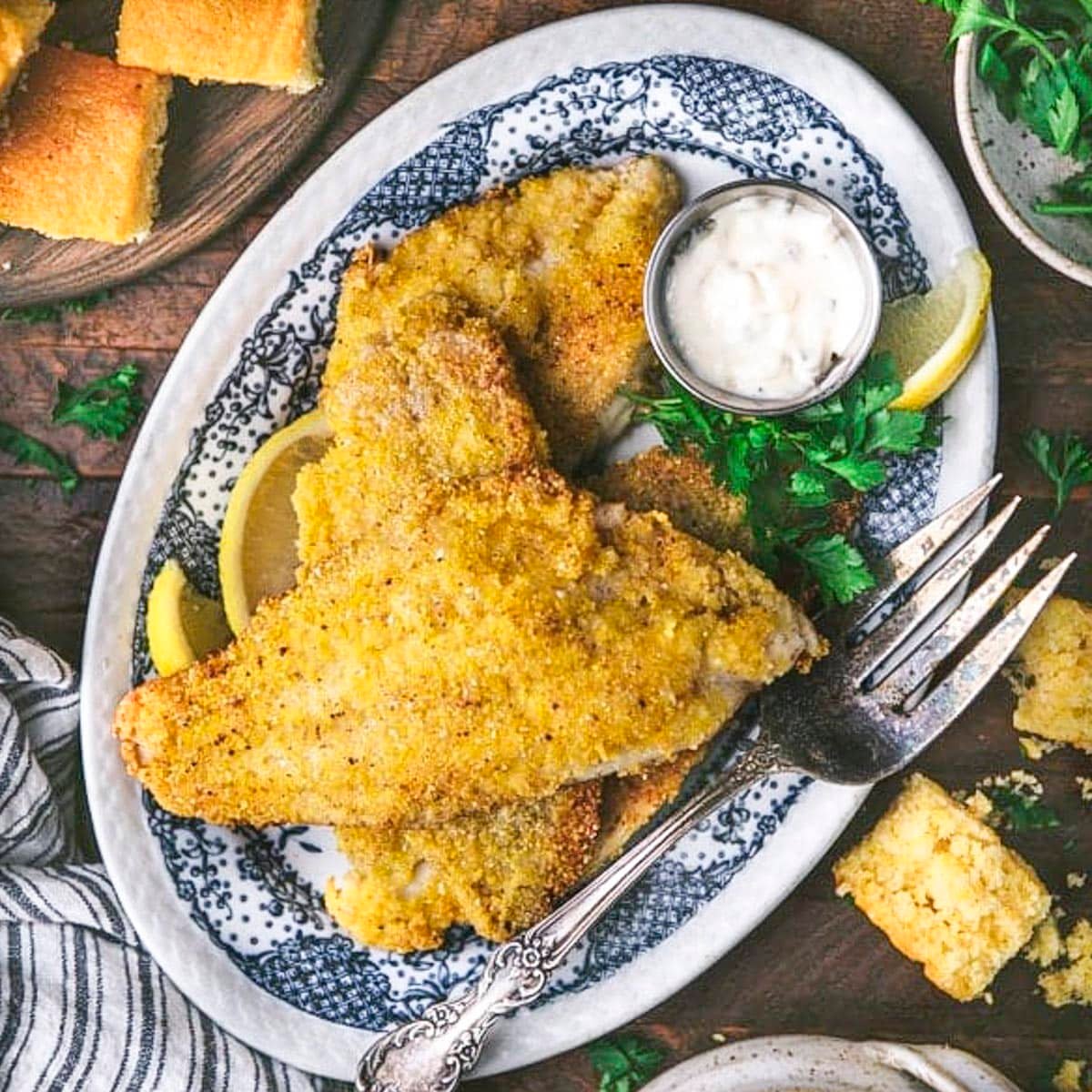 Square overhead shot of southern fried catfish on a blue and white tray.