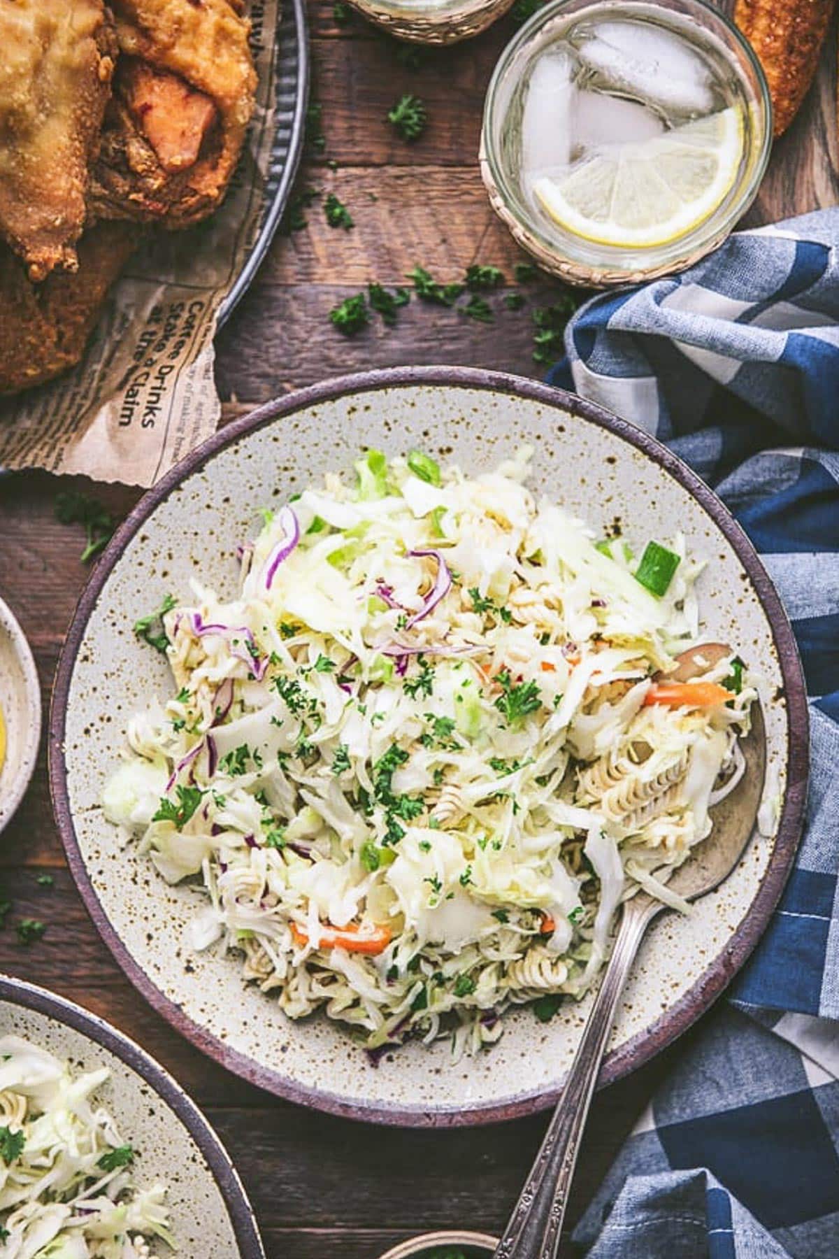 Overhead shot of a bowl of chinese coleslaw on a wooden table.