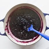 Homemade blueberry jam in a Dutch oven.