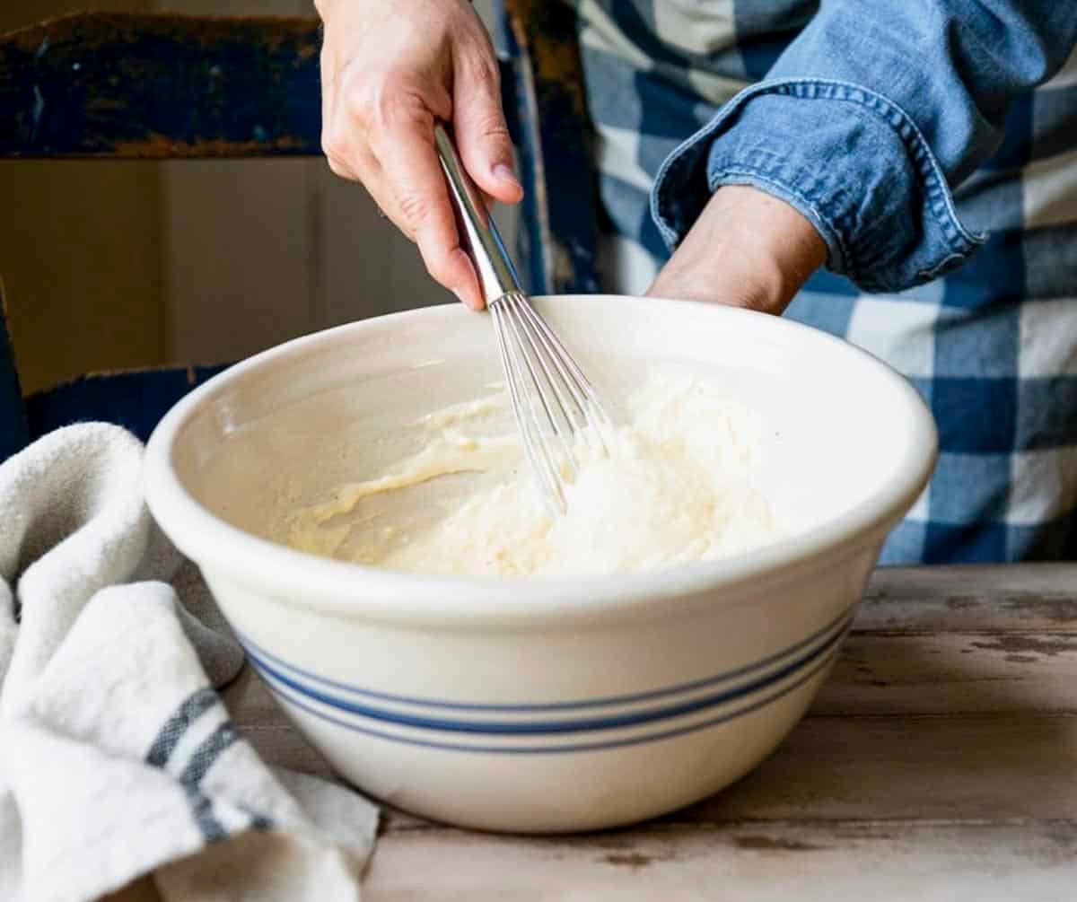 Whisking together mayo mixture in a bowl.