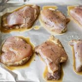 Process shot showing how to bake boneless skinless chicken thighs.