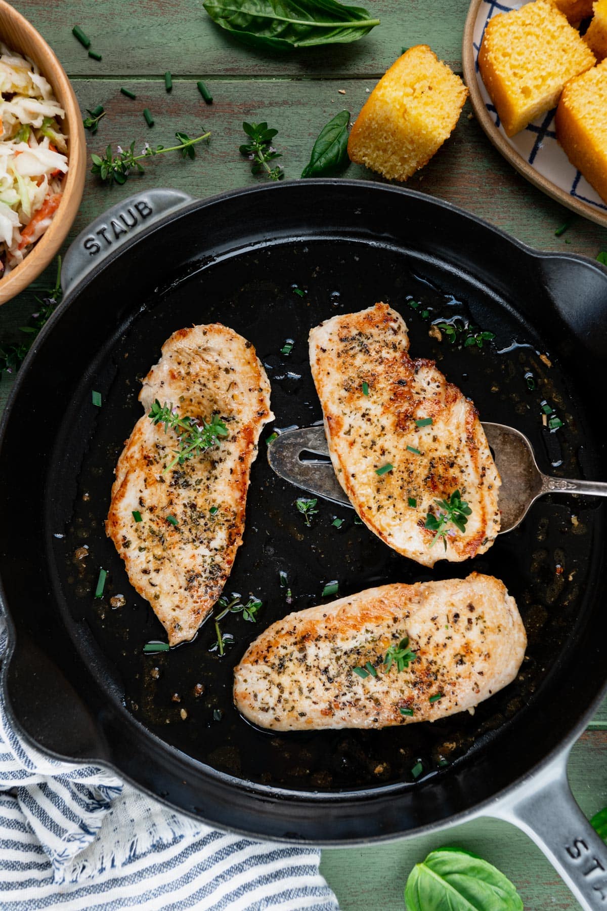 Overhead image of chicken breast in a cast iron skillet.