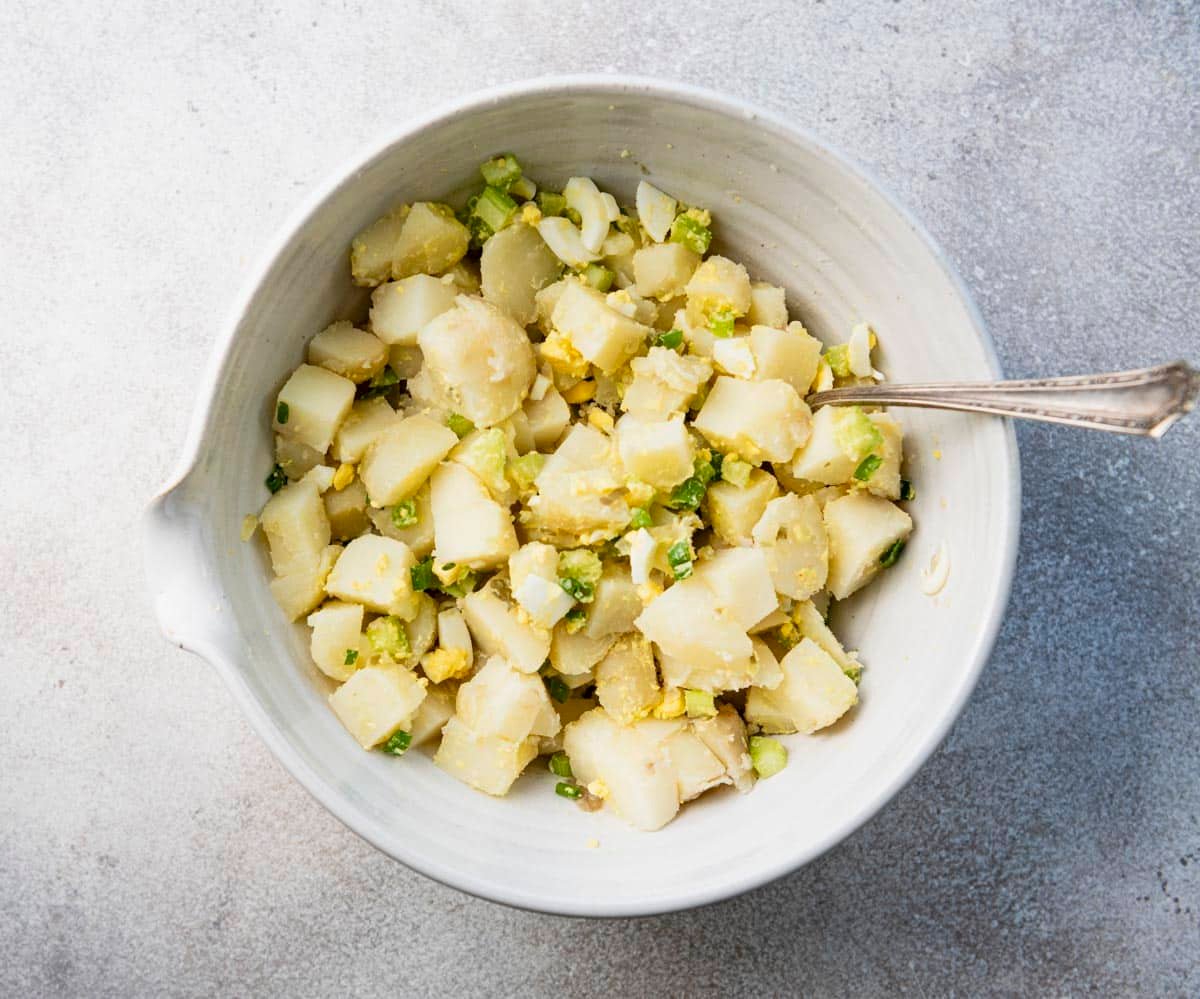 Stirring together ingredients for southern potato salad.
