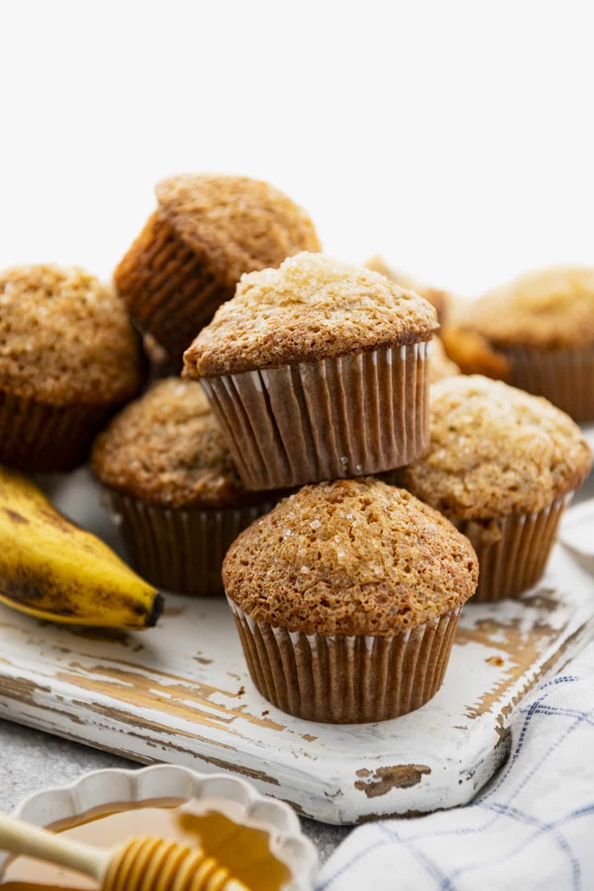 Front shot of easy banana nut muffins on a white table.