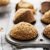 Banana nut muffins with high domes in a vintage muffin tin.
