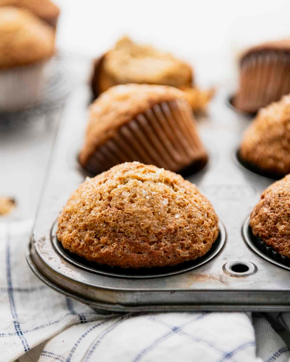 Banana nut muffins with high domes in a vintage muffin tin.
