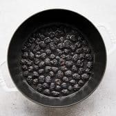 Ingredients for simple blackberry syrup in a Dutch oven.