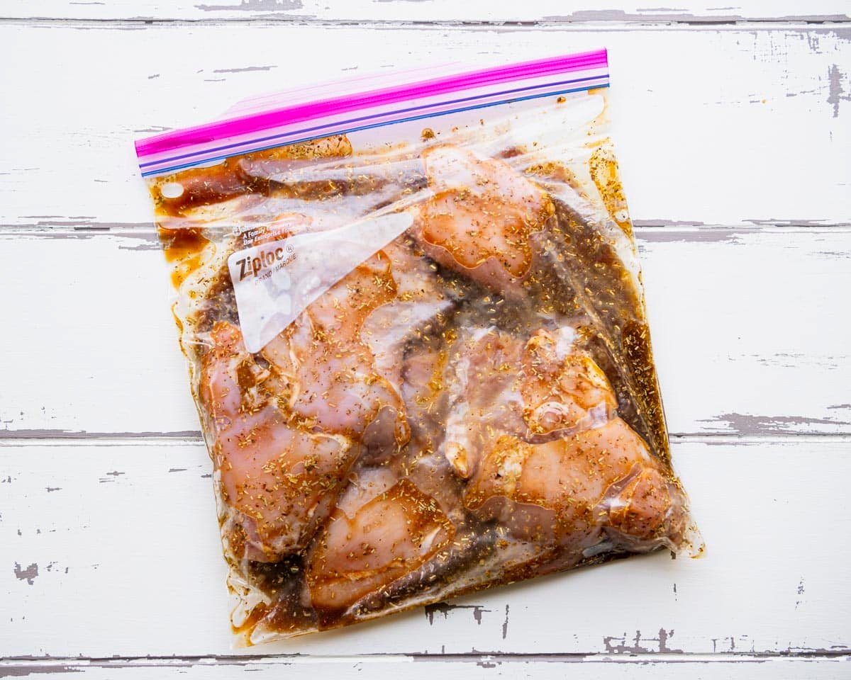 Boneless skinless chicken thighs in the best chicken thigh marinade in a Ziploc bag.