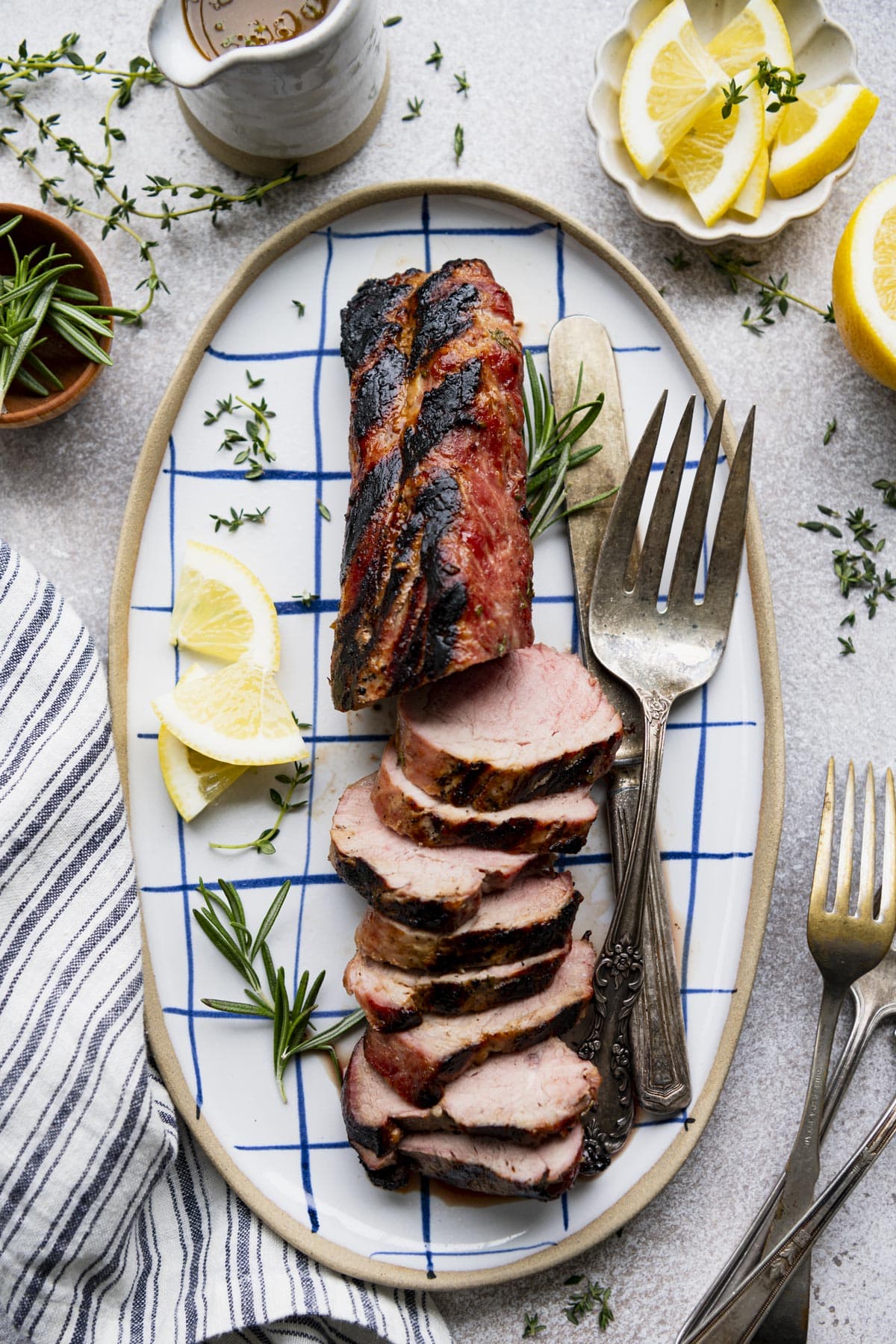 Simple pork tenderloin on a pork tenderloin that's grilled, sliced, and served on a white table.