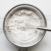 Dry ingredients whisked together in a metal bowl.